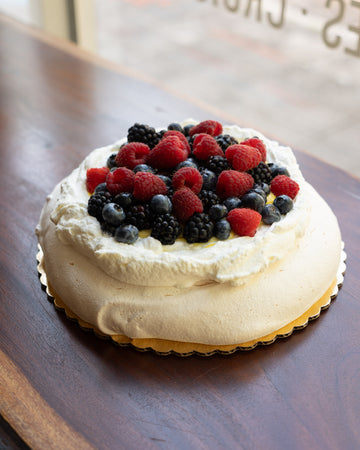 *Pavlova with Passion Fruit Curd, Whipped Cream and Assorted Fresh Berries